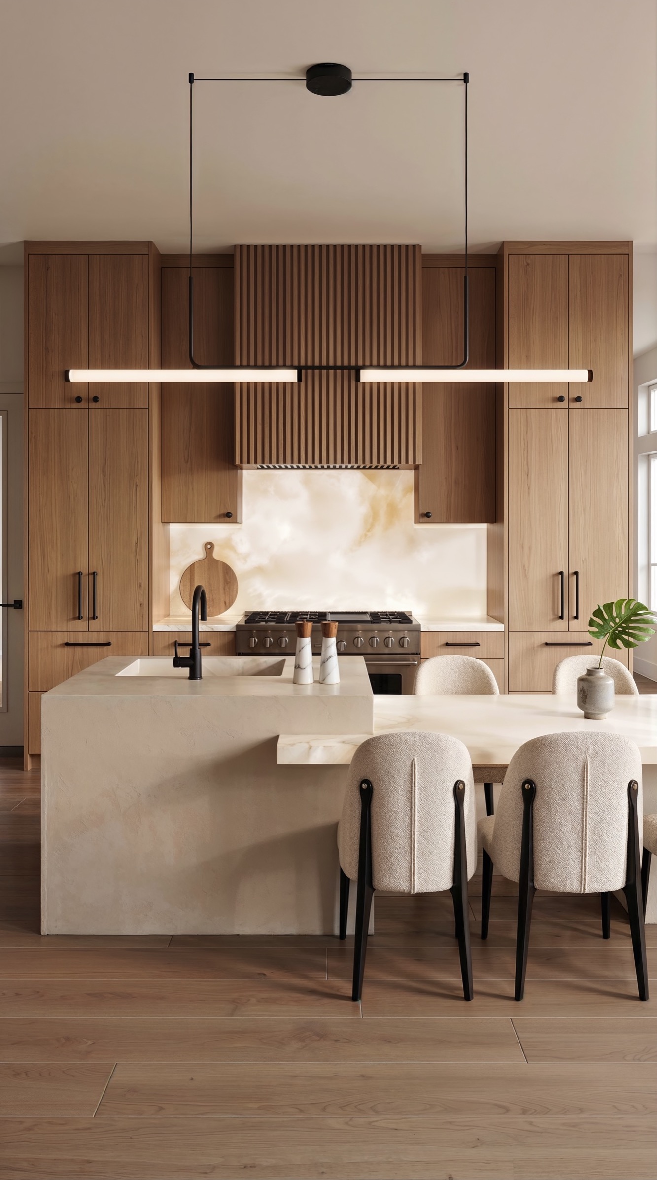 Soft earth kitchen with walnut cabinetry and an illuminated stone backsplash